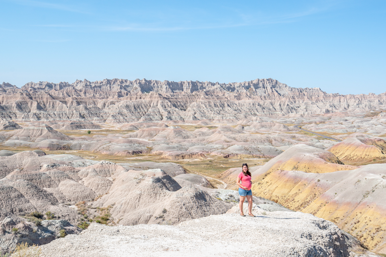 kate storm wearing a pink shirt in badlands national park while pregnant