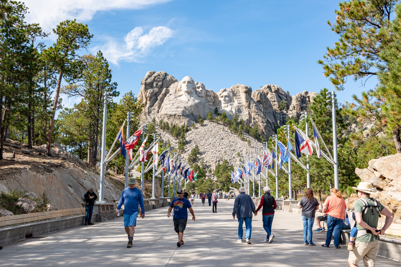 mount rushmore national memorial with people walking toward it in the foreground