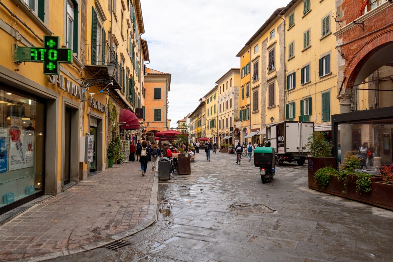 pedestrian street in pisa italy on a cloudy day