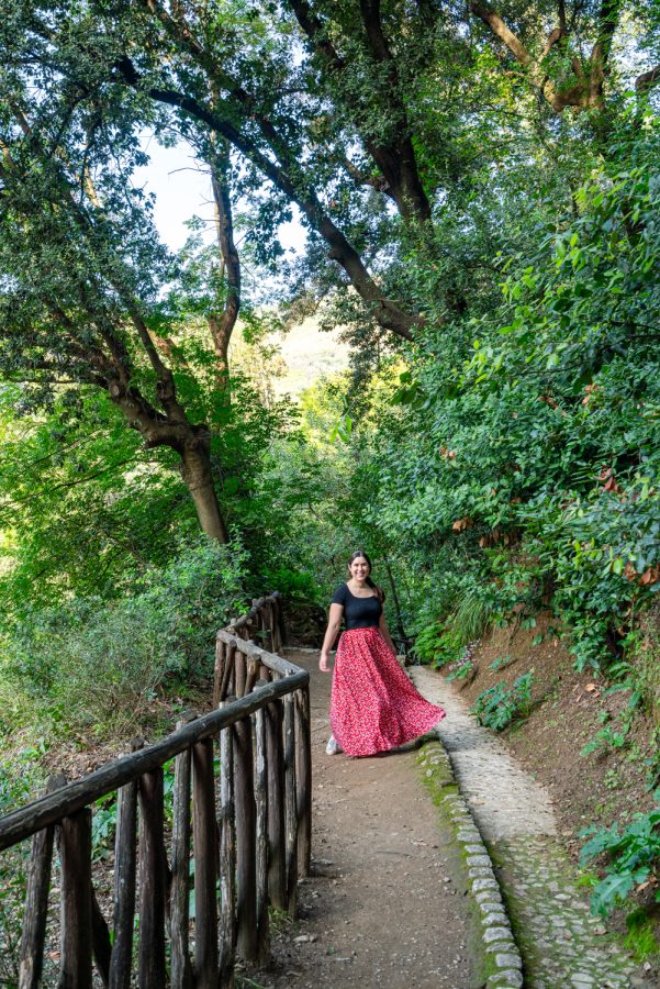 kate storm at villa gregoriana hiking down a path with a wooden railway tivoli italy